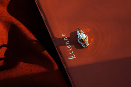 Executive holding premium top-grain leather tennis racket bag in mint green with gold hardware, perfect for business professionals